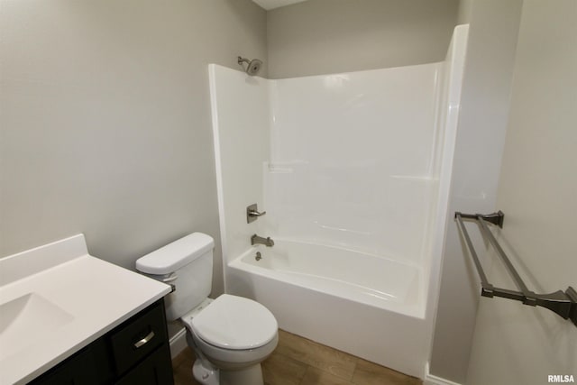 full bathroom with wood-type flooring, vanity, shower / bath combination, and toilet