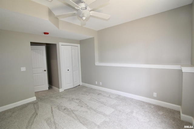 unfurnished bedroom with light carpet and ceiling fan