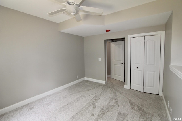 unfurnished bedroom with ceiling fan and light carpet