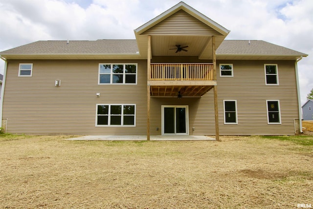 rear view of property with ceiling fan, a balcony, and a patio