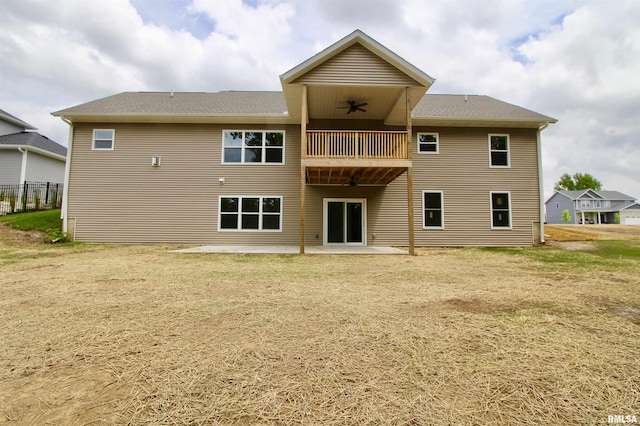 rear view of property featuring ceiling fan, a balcony, and a patio