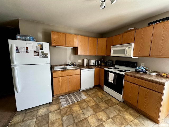 kitchen with white appliances, sink, and a textured ceiling