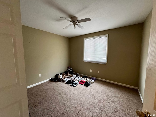 empty room with ceiling fan, carpet, and a textured ceiling