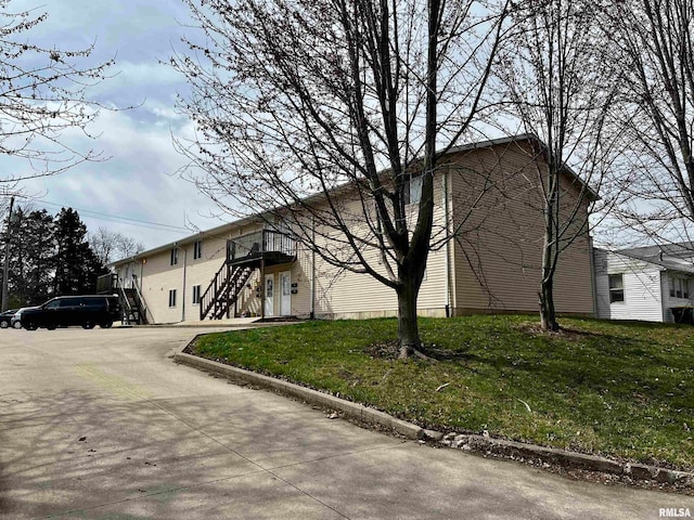 view of side of home featuring a lawn