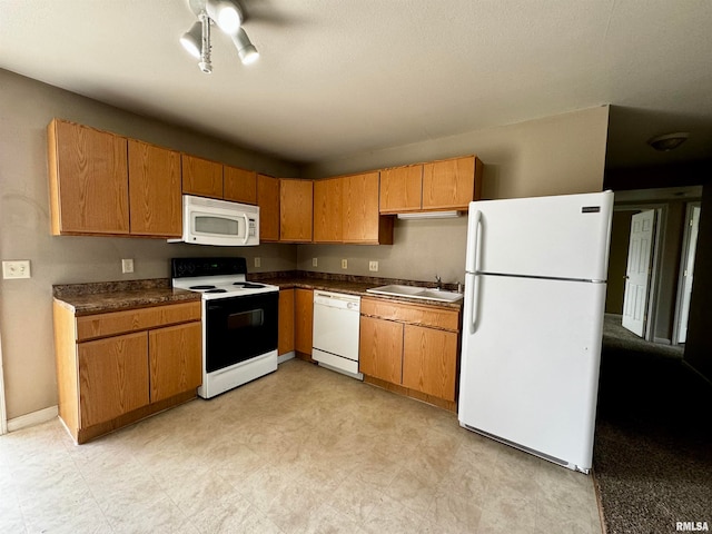 kitchen featuring white appliances, sink, and ceiling fan