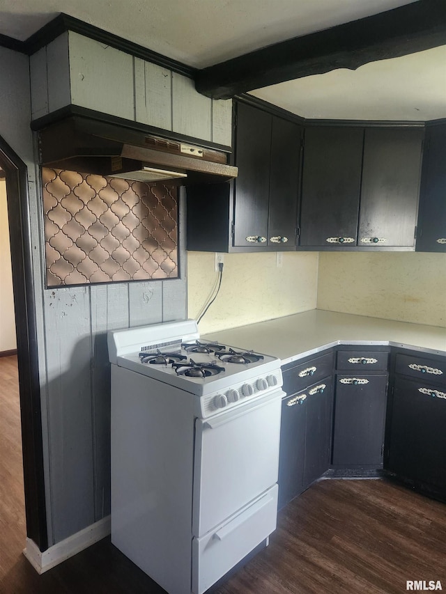 kitchen with white gas range, dark wood-type flooring, and beamed ceiling