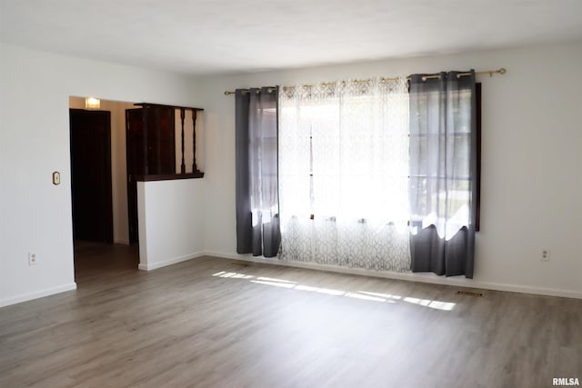 carpeted empty room with ornamental molding, a large fireplace, and a chandelier