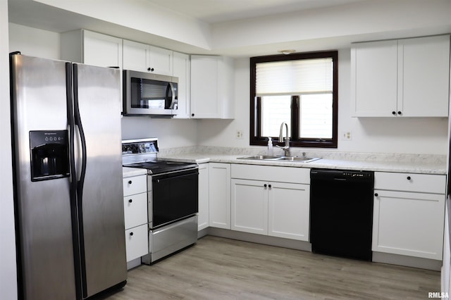 kitchen featuring light hardwood / wood-style floors, white appliances, a brick fireplace, dark brown cabinetry, and tasteful backsplash