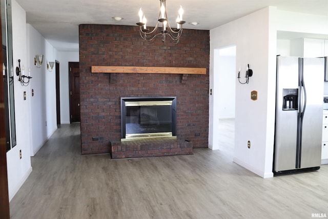 living room featuring an inviting chandelier and light wood-type flooring