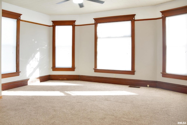 carpeted empty room featuring ceiling fan