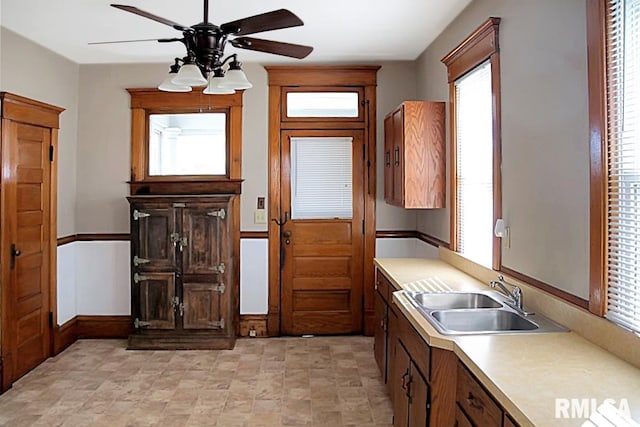 kitchen with plenty of natural light, sink, ceiling fan, and light tile floors