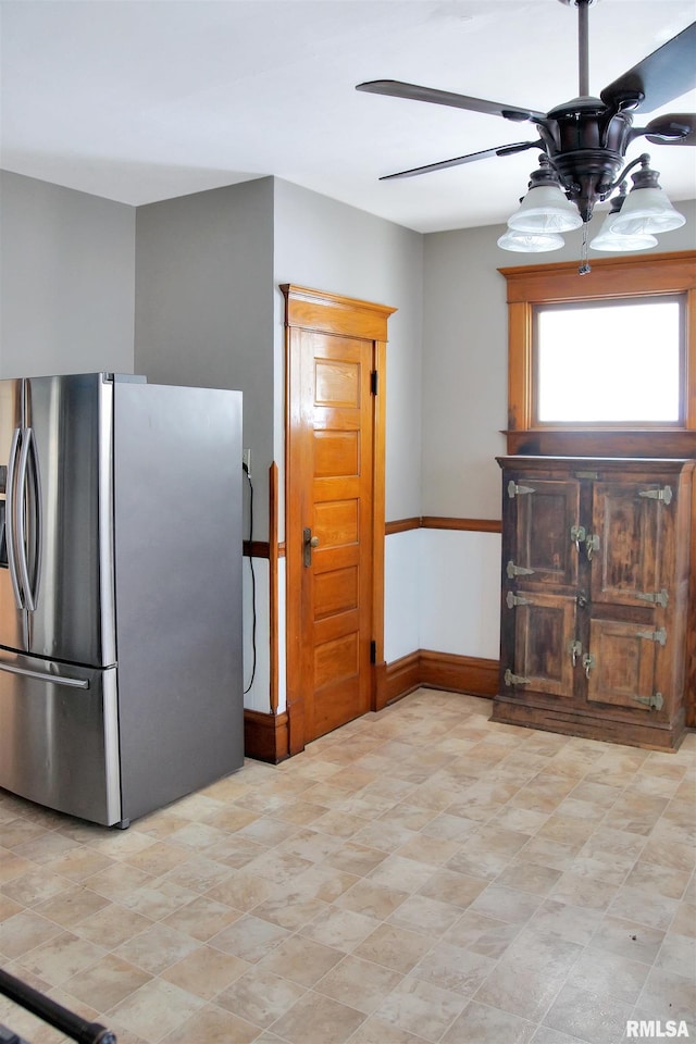 kitchen with ceiling fan, stainless steel fridge, and light tile flooring