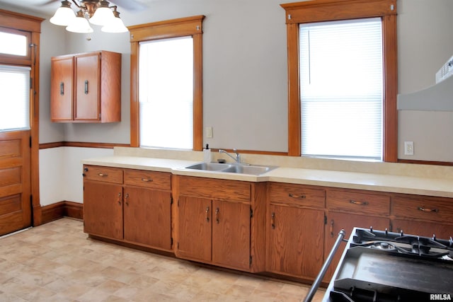 kitchen with sink, ceiling fan, light tile floors, and range