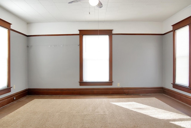 spare room featuring ceiling fan and carpet flooring