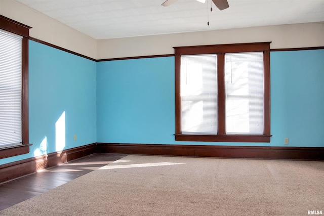 empty room with ceiling fan and carpet flooring