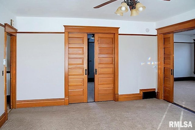 unfurnished bedroom with ceiling fan and carpet floors