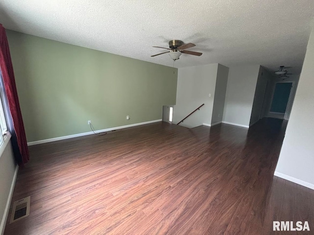 spare room with ceiling fan, wood-type flooring, and a textured ceiling