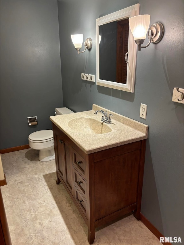 bathroom featuring vanity, toilet, and tile patterned flooring