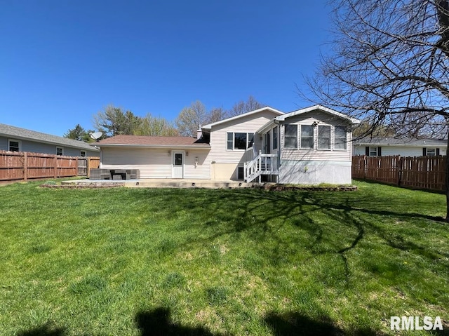 rear view of house with a patio area and a yard