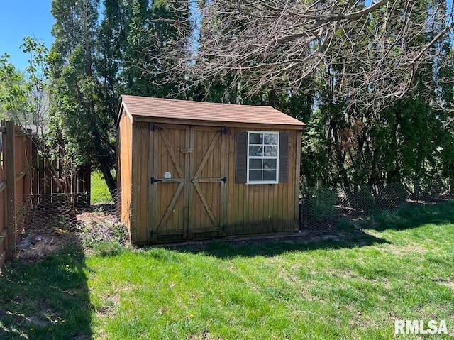 view of outbuilding with a yard