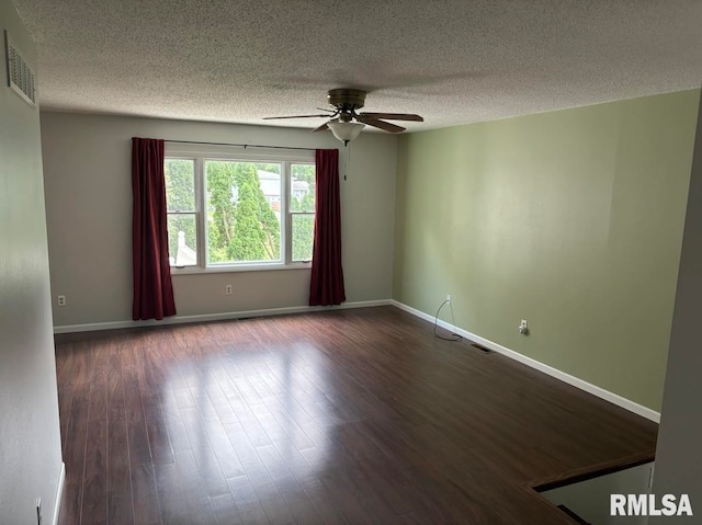 empty room featuring a textured ceiling, hardwood / wood-style floors, and ceiling fan