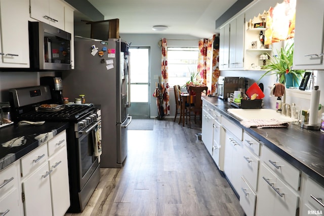 kitchen featuring light hardwood / wood-style flooring, stainless steel appliances, and white cabinetry