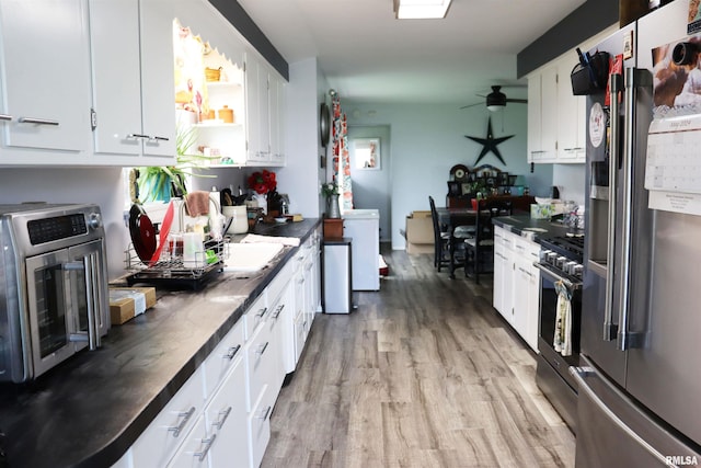 kitchen with light wood-type flooring, ceiling fan, white cabinetry, and stainless steel appliances