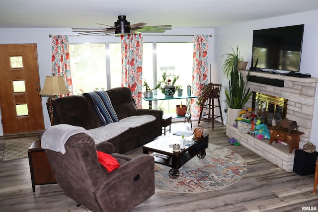 living room with a fireplace, hardwood / wood-style floors, and ceiling fan