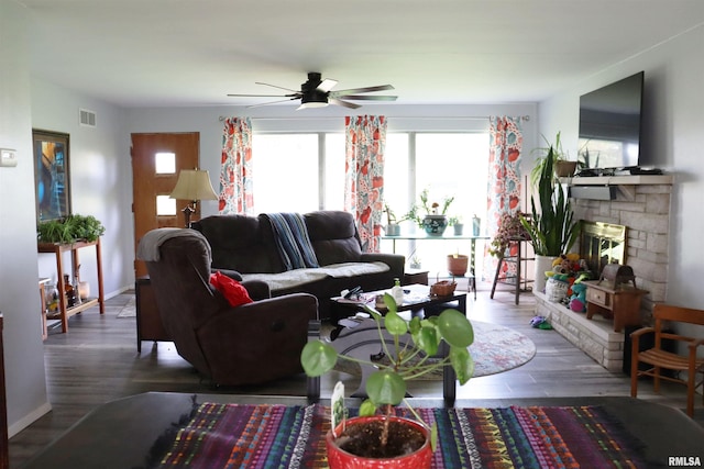 living room with a healthy amount of sunlight, hardwood / wood-style floors, and a fireplace