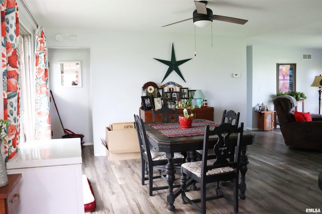 dining space with hardwood / wood-style flooring and ceiling fan