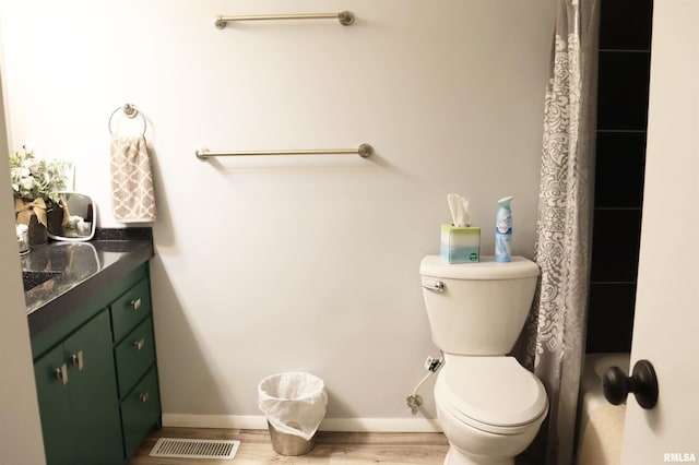 bathroom featuring hardwood / wood-style floors, vanity, and toilet