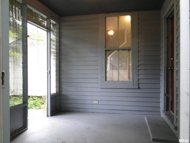 unfurnished sunroom with plenty of natural light