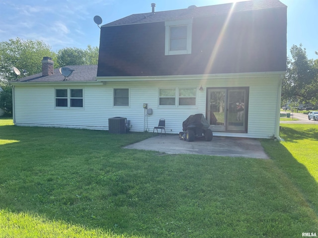 back of house with a yard, central air condition unit, and a patio