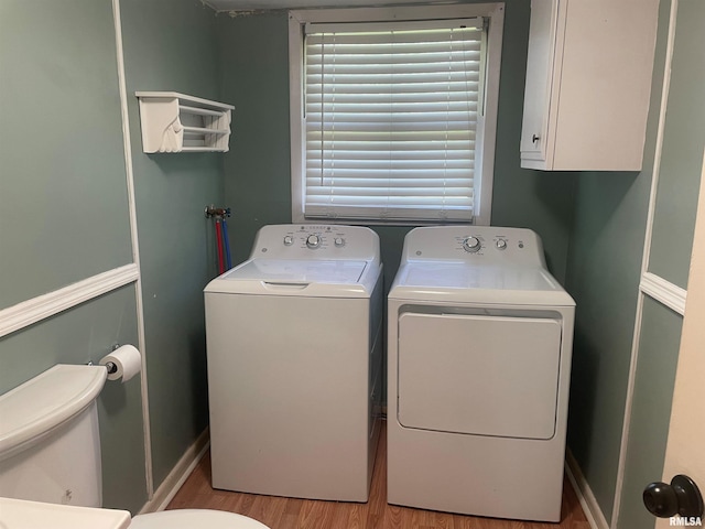 laundry area with washer and clothes dryer and wood-type flooring