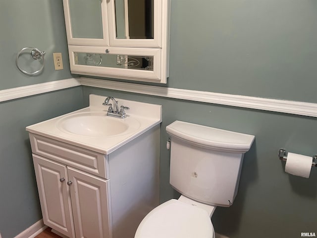 bathroom featuring oversized vanity and toilet