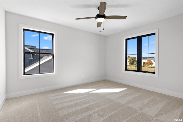 spare room featuring carpet flooring and ceiling fan