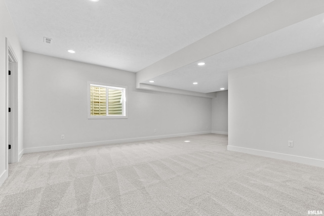 spare room featuring light colored carpet