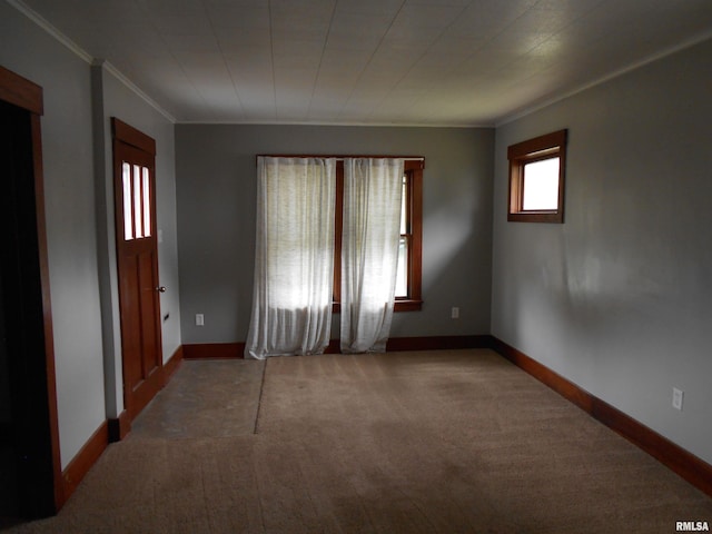 carpeted spare room with crown molding