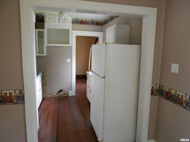 kitchen with dark hardwood / wood-style flooring and white fridge