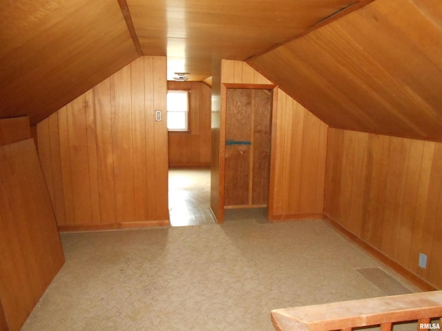 bonus room with light carpet, vaulted ceiling, wooden ceiling, and wood walls