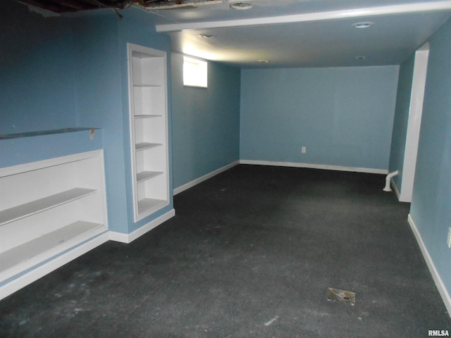 basement featuring dark colored carpet