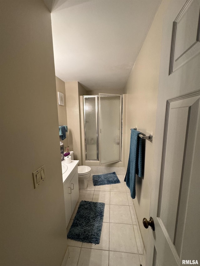 bathroom with tile patterned flooring, vanity, and toilet