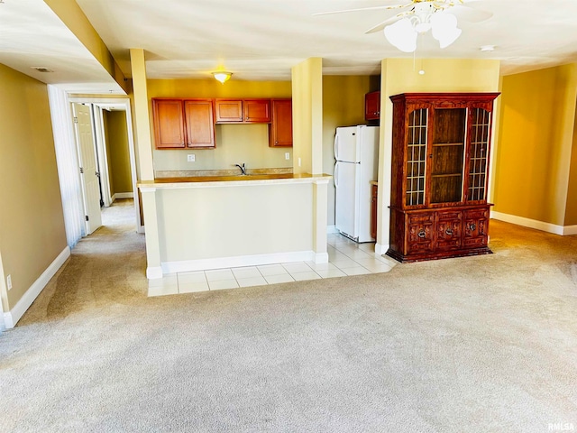 kitchen with white refrigerator, light colored carpet, ceiling fan, and sink