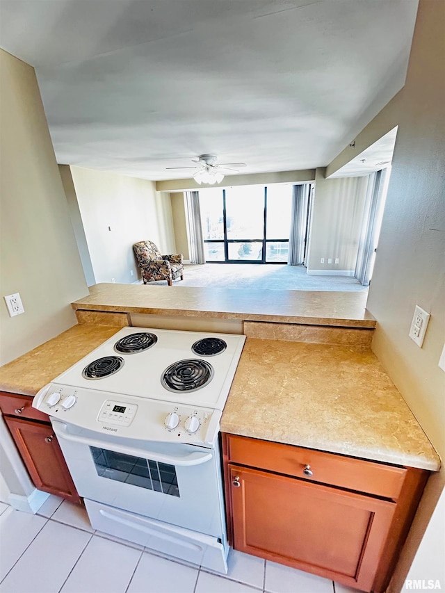 kitchen featuring white range with electric cooktop, ceiling fan, and light tile patterned floors