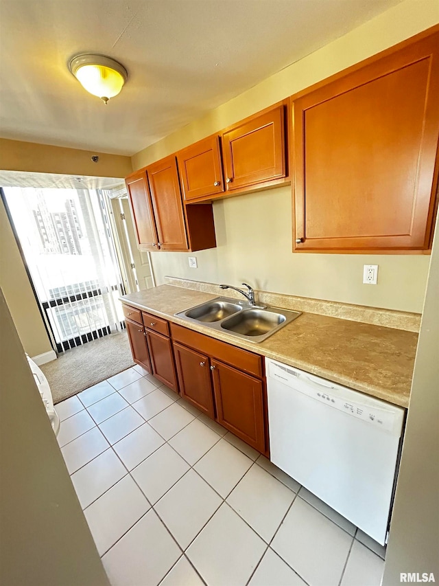 kitchen featuring light tile patterned floors, white dishwasher, and sink