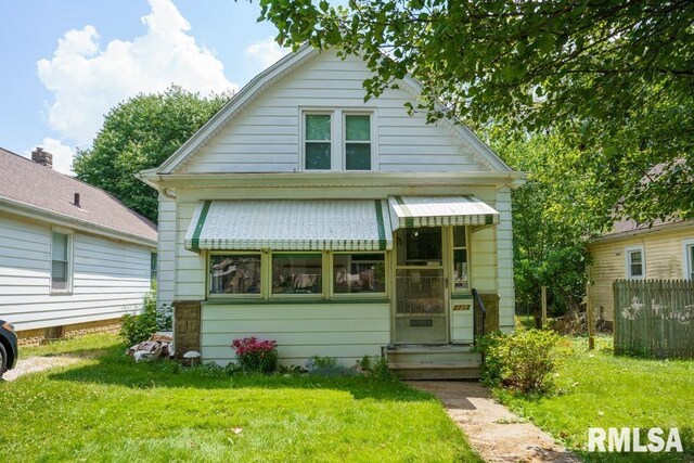 bungalow-style home featuring a front yard