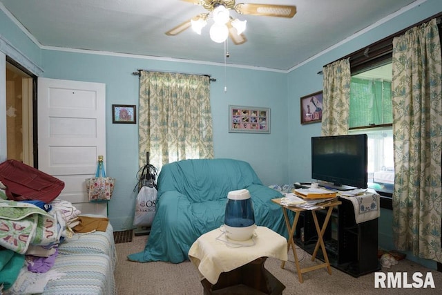 carpeted living room with crown molding and ceiling fan