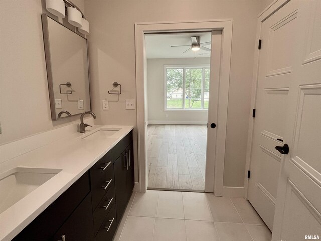 bathroom featuring ceiling fan, dual bowl vanity, and hardwood / wood-style flooring