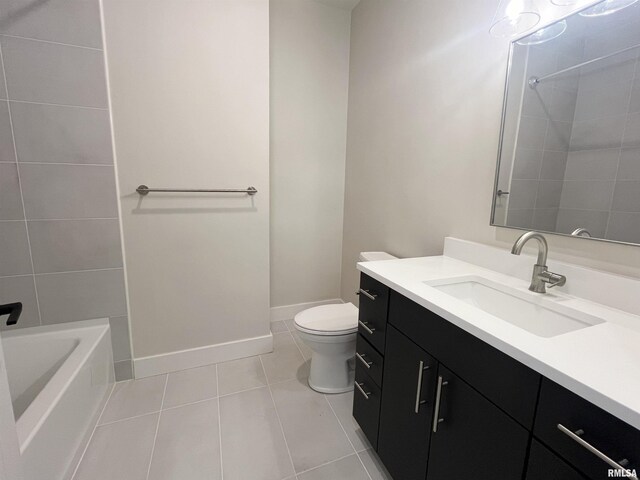 full bathroom with tiled shower / bath combo, tile patterned floors, vanity, and toilet