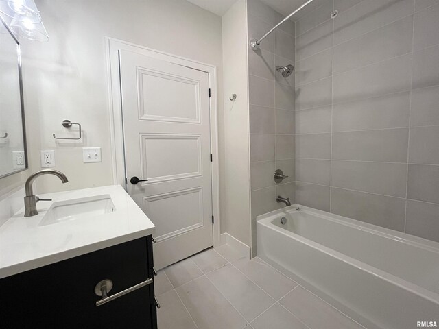 bathroom with vanity, tiled shower / bath combo, and tile patterned flooring